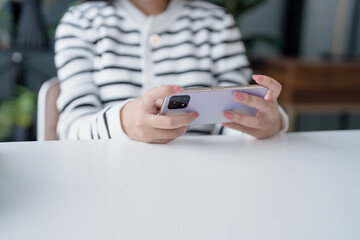 Asian Girl Enjoying Video Game on Smartphone