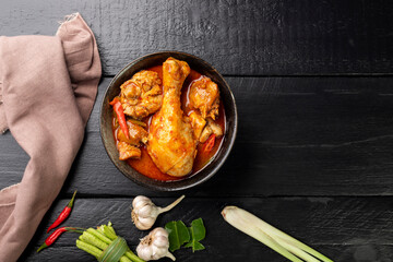 Herbal Chicken Leg Curry or Healthy Cooked Food Stew Arranged on Black Wooden Table, Top View
