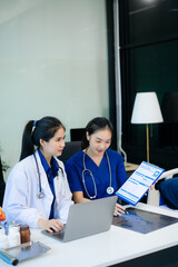 Medical professionals brainstorming with laptop in hospital office for health planning, research, and management.