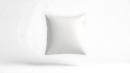 Minimalist white pillow floating against a clean white background