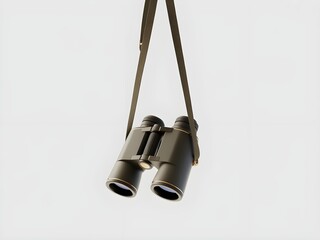 Binoculars with neck strap hanging against a light background