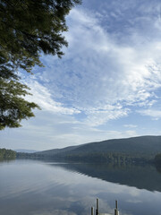 landscape of a lake with nature trees and a blue sky full of clouds