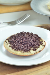 Serabi pancake with chocolate sprinkles topping, a traditional Indonesian snack.