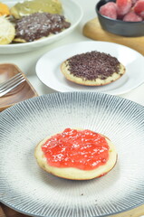 Serabi pancakes topped with strawberry jam, a traditional Indonesian snack