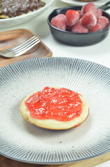 Serabi pancakes topped with strawberry jam, a traditional Indonesian snack