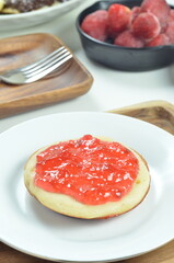 Serabi pancakes topped with strawberry jam, a traditional Indonesian snack