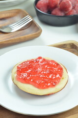 Serabi pancakes topped with strawberry jam, a traditional Indonesian snack