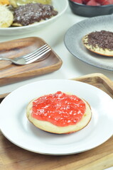 Serabi pancakes topped with strawberry jam, a traditional Indonesian snack