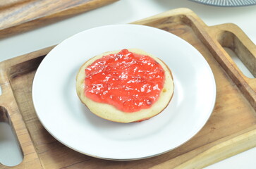Serabi pancakes topped with strawberry jam, a traditional Indonesian snack