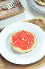 Serabi pancakes topped with strawberry jam, a traditional Indonesian snack