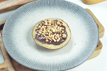 Serabi pancakes with chocolate and peanut butter toppings, a traditional Indonesian snack