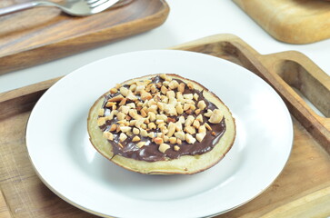 Serabi pancakes with chocolate and peanut butter toppings, a traditional Indonesian snack