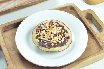 Serabi pancakes with chocolate and peanut butter toppings, a traditional Indonesian snack