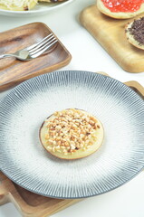 Serabi pancake with peanut topping and condensed milk, a traditional Indonesian snack