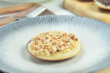 Serabi pancake with peanut topping and condensed milk, a traditional Indonesian snack
