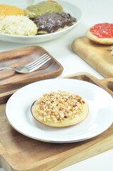Serabi pancake with peanut topping and condensed milk, a traditional Indonesian snack