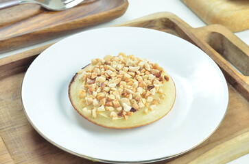 Serabi pancake with peanut topping and condensed milk, a traditional Indonesian snack