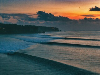 Long peeling lefts come through Impossibles, Bingin, Bali, Indonesia at sunset. Taken with a drone...