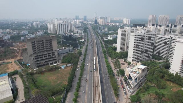 Aerial Drone Footage of Gurgaon Gurugram Buildings skyline Rapid Metro Road Cars traffic in gurgaon city Haryana Delhi NCR
