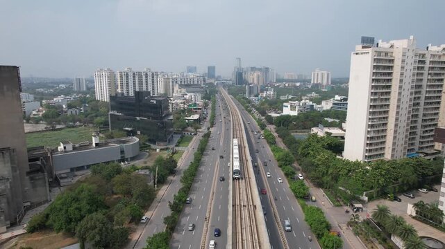 Aerial Drone Footage of Gurgaon Gurugram Buildings skyline Rapid Metro Road Cars traffic in gurgaon city Haryana Delhi NCR