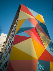 Close up view of modern colorful triangular design on a tall residential housing block in an old Singapore HDB public housing estate © Stanley Fong