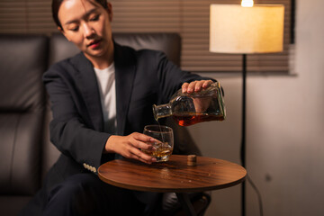 Businesswoman holding a glass of whiskey
