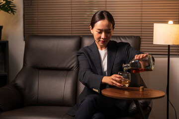 Businesswoman holding a glass of whiskey
