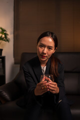 Businesswoman holding a glass of whiskey