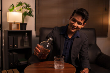 Businessman holding a glass of whiskey in a restaurant sitting on a sofa