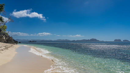 Beautiful secluded tropical beach on the island. Reflections on the surface of a calm turquoise...