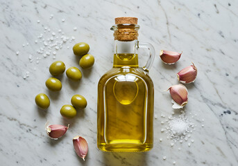 Olive Oil Bottle with Green Olives and Garlic Cloves on Marble | Fresh Mediterranean Ingredients for Cooking, Food Blog and Healthy Eating Concepts