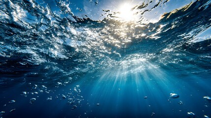 Sunlight streams through the deep blue ocean.
