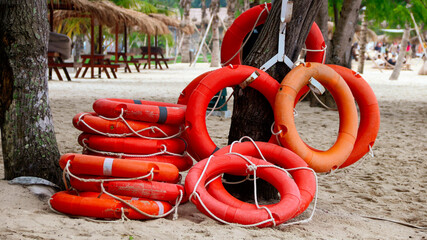Orange life jackets as swimming aids, rubber rings for swimming at rental shops. Black rubber rings...
