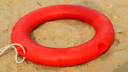 Orange life jackets as swimming aids, rubber rings for swimming at rental shops. Black rubber rings...