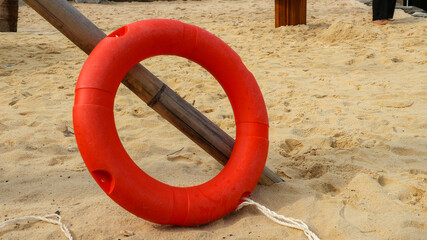 Orange life jackets as swimming aids, rubber rings for swimming at rental shops. Black rubber rings...
