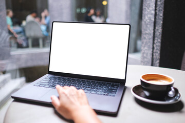 Mockup image of a woman working and typing on laptop computer with blank white desktop screen in cafe