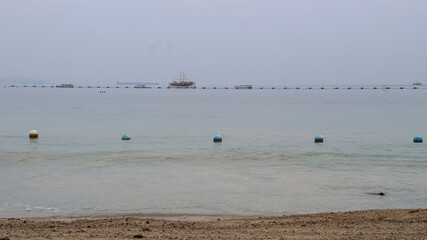 A series of blue and white buoys in the calm waters of a lake. Used as boundary markers to demarcate swimming areas.