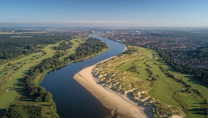 River meanders through a landscape of sand dunes and golf courses
