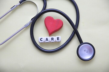 Stethoscope with Red Heart and CARE Text Blocks – Healthcare and Heart Wellness Concept