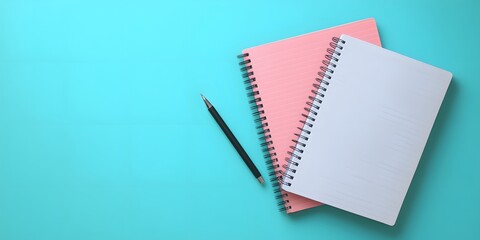 Spiral notebook & pen on vibrant blue surface