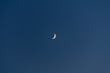crescent moon in the blue sky