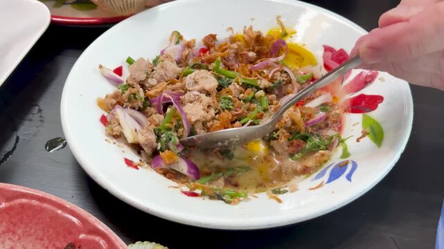 Mixing Spicy Minced Pork Salad in Thai Restaurant