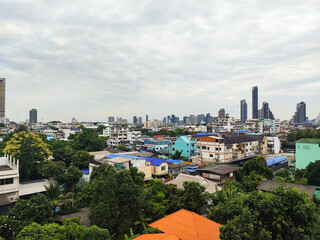 A crowded urban area with houses and tall buildings, a corner of Bangkok in Thailand.