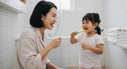 Mother daughter brushing teeth