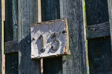A weathered house number 