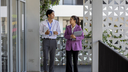 business people are talking while walking in the company, all the planning department staff are walking to a meeting together, business owners are talking while walking to the office