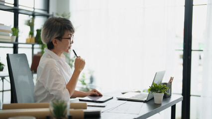Senior business asian woman mature working in office