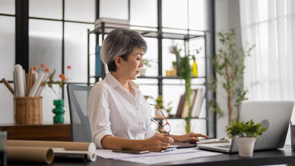 Senior business asian woman mature working in office