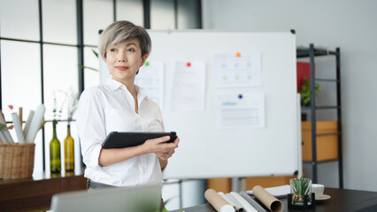 Senior business asian woman mature working in office