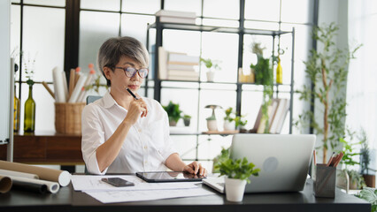 Senior business asian woman mature working in office